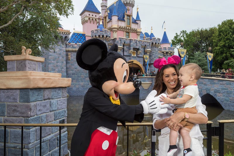 Mickey Mouse hugs child
