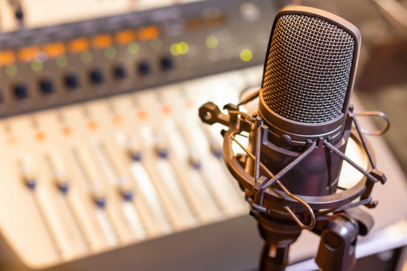 Radio microphone with soundboard in the background