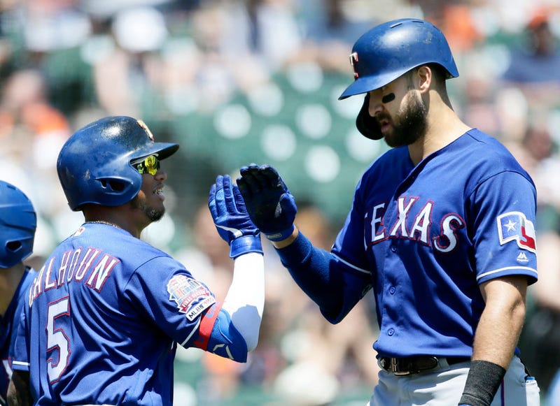 Joey Gallo #13 of the Texas Rangers receives a high-five from Willie Calhoun #5 of the Texas Rangers after hitting a solo home run against the Detroit Tigers during the fourth inning at Comerica Park on June 27, 2019 in Detroit, Michigan.