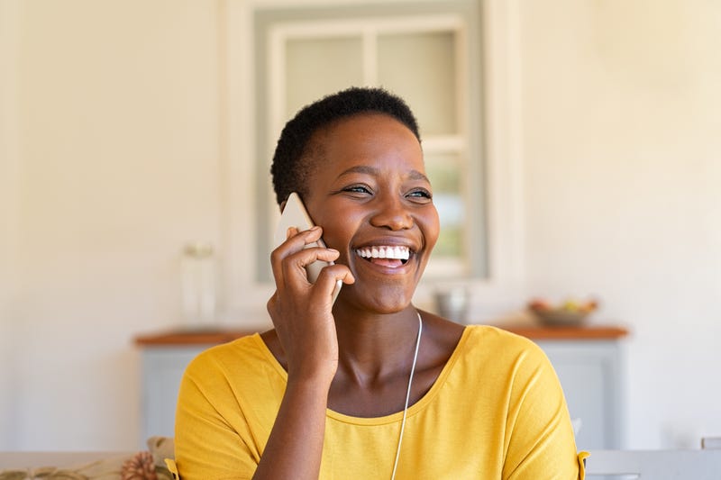 A woman laughs on the phone
