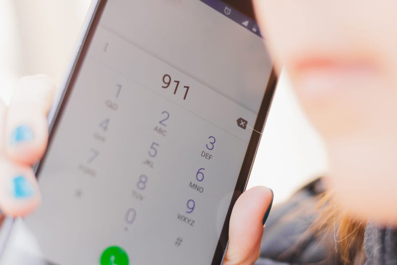 Closeup of a phone as person calls 911.