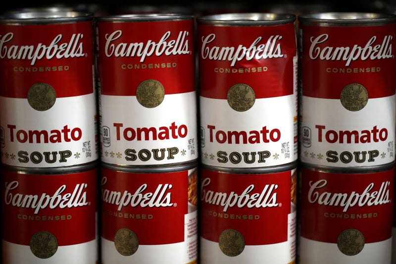  Can of Campbell's soup are displayed on a shelf at a grocery store