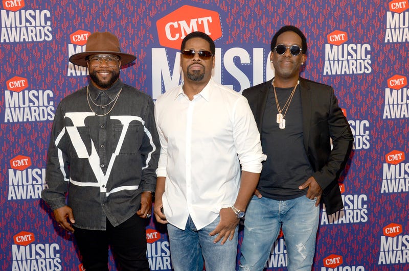 Musical act Boyz II Men posing on the red carpet at 2019 CMT Music Awards
