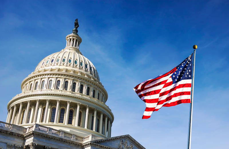 American flag waving with the Capitol Hill