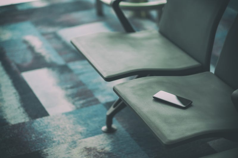 Missing phone on airport seat stock photo.