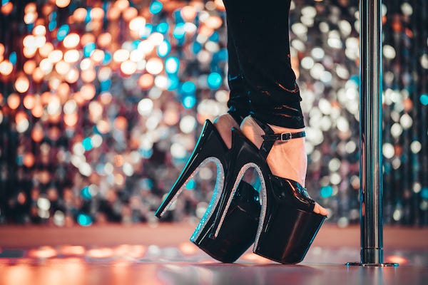 Large heels standing next to pole