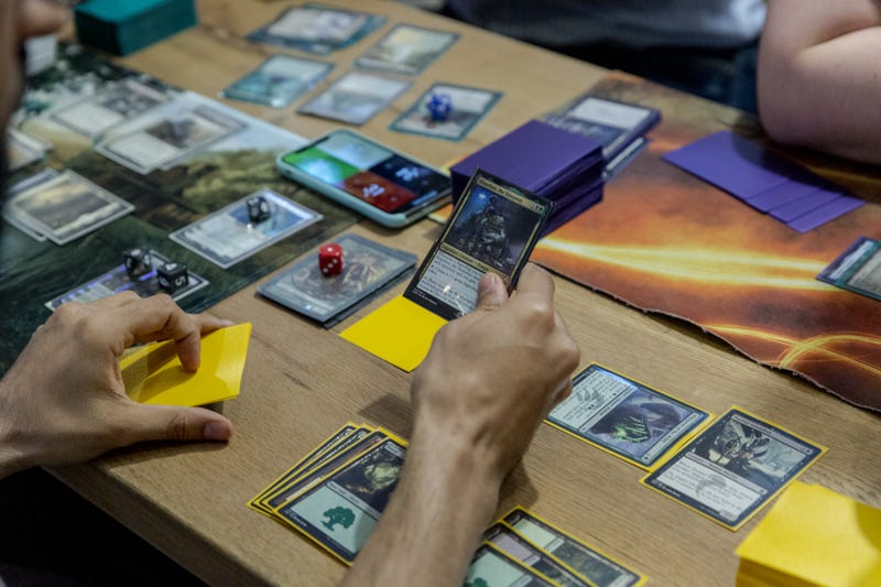 Participants play a Magic: The Gathering card game during a weekly tournament at the Uncommons hobby shop in New York, U.S., on Thursday, June 27, 2019.
