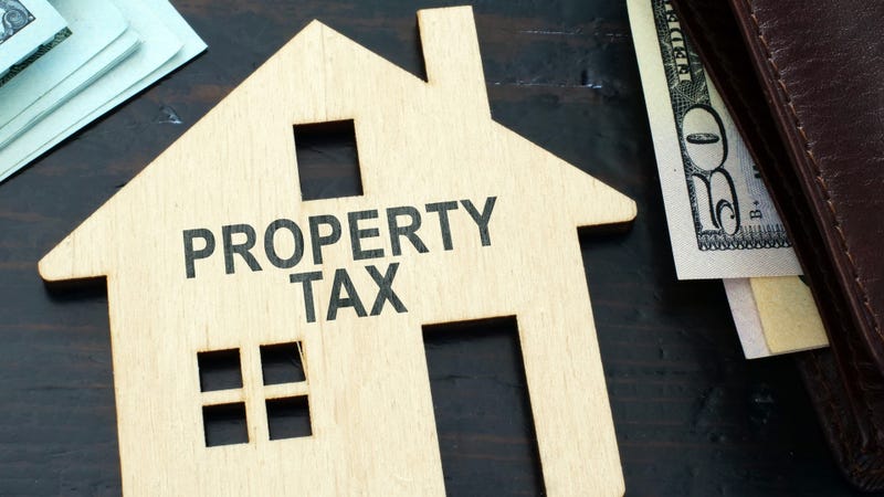 Property tax sign on a house model