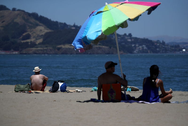 People sit on the beach at Crissy Field East Beach on June 11, 2019 in San Francisco, California. 