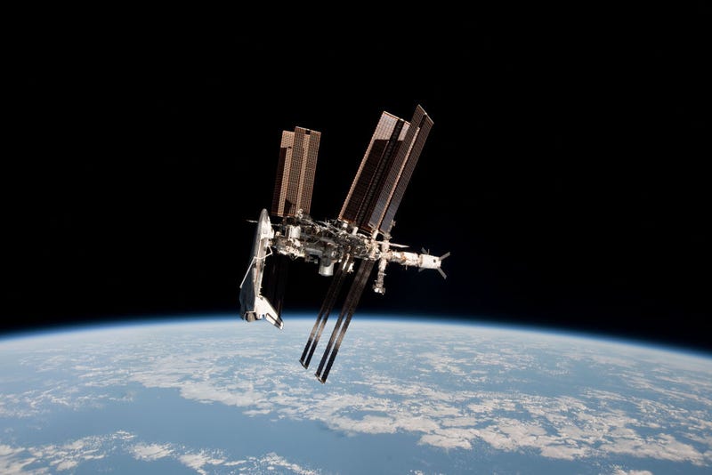 In this handout image provided by the European Space Agency (ESA) and NASA, the International Space Station and the docked space shuttle Endeavour orbit Earth during Endeavour's final sortie on May 23, 2011 in Space. Astronauts on the space station had to take emergency precautions Monday, Nov. 15, 2021 when a Russian missile test created space debris. (Photo by Paolo Nespoli - ESA/NASA via Getty Images)