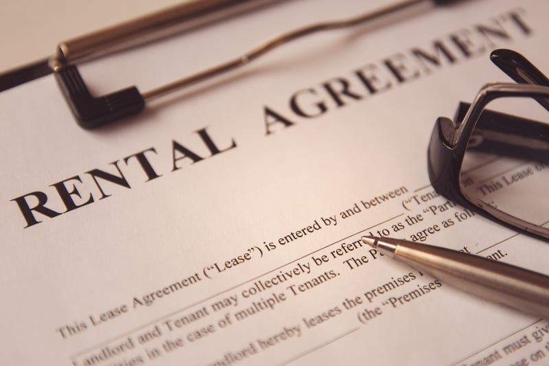 Pen and glasses on a rental agreement form.