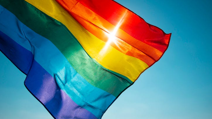 Couple told to take down Pride flag, so they lit up the neighborhood instead