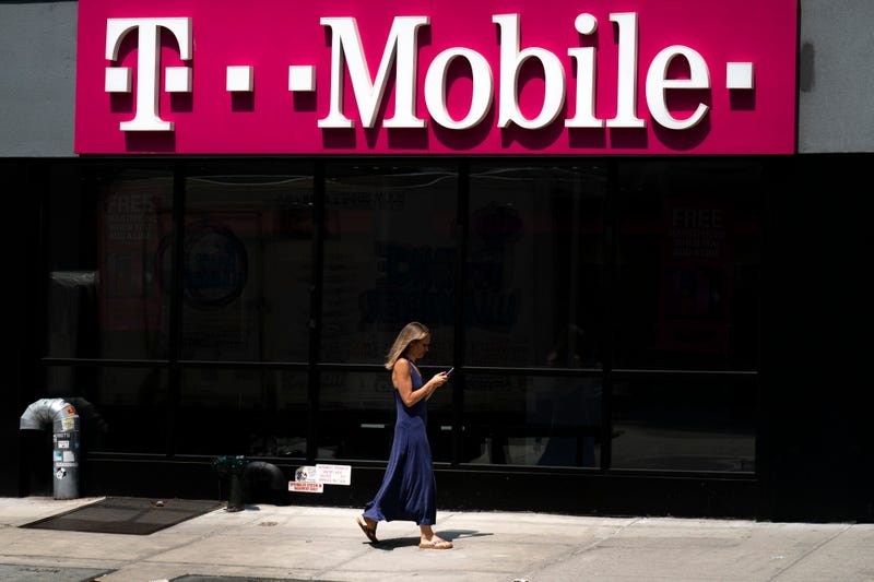 A woman walks past a T-Mobile store in Manhattan.