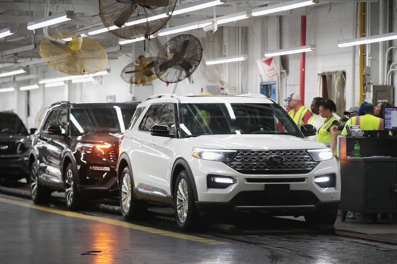 A Ford Explorer gets a final inspection on the assembly line.