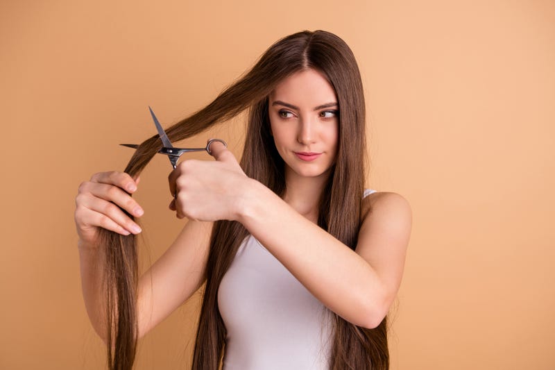 woman cutting her own hair