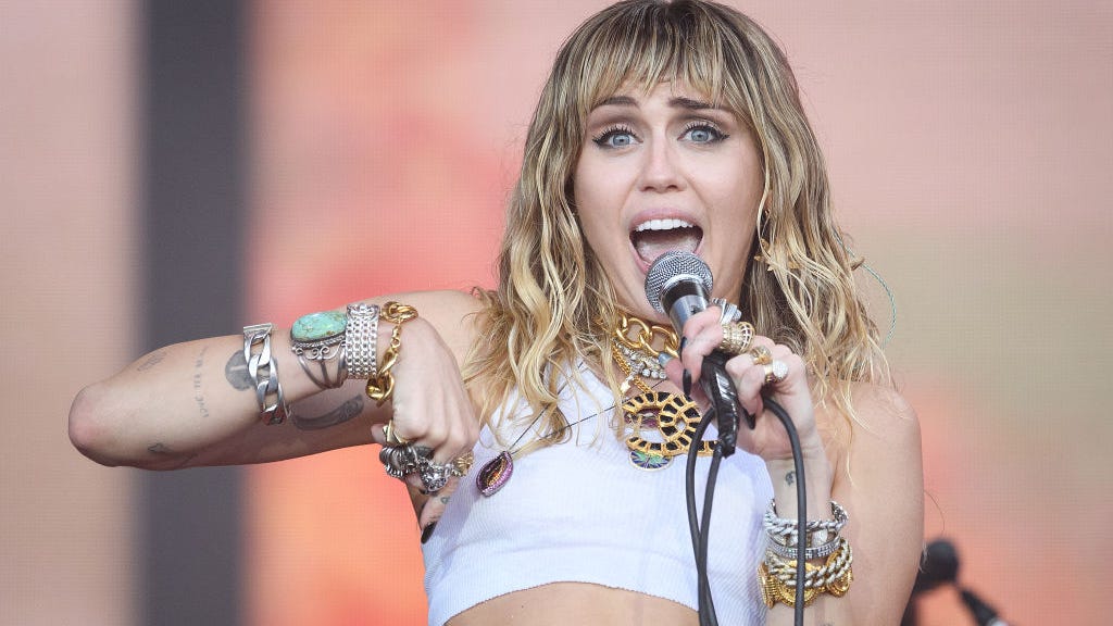 Look: Miley Cyrus poses nude in casket