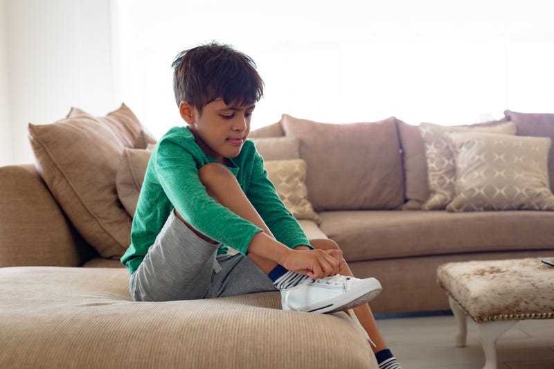 boy tying shoe