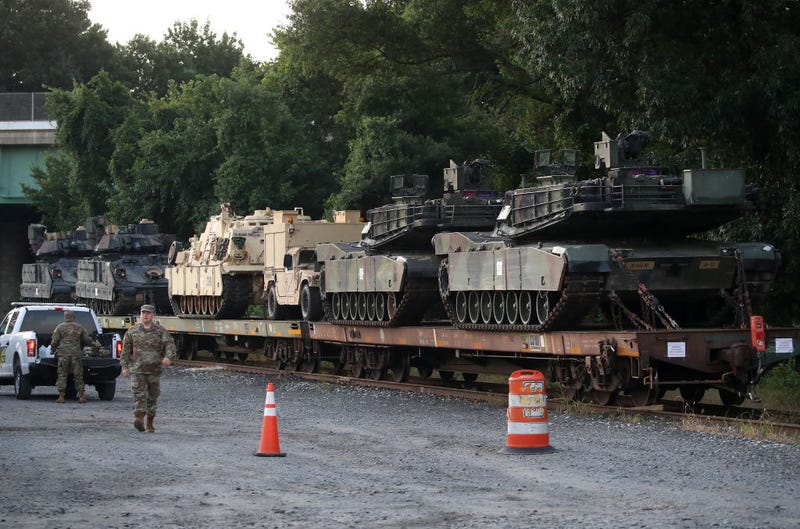 Two M1A1 Abrams tanks and other military vehicles sit on guarded rail cars at a rail yard on July 2, 2019 in Washington, DC. 