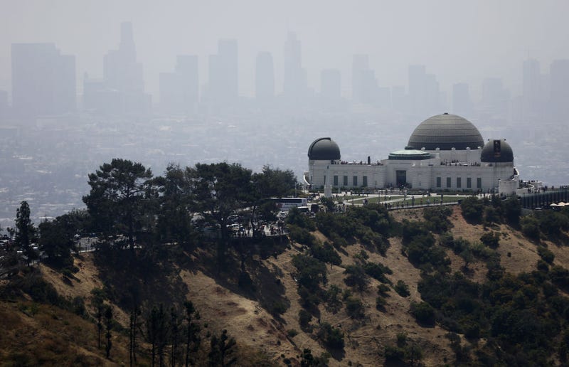 The Griffith Observatory stands (R) in front of downtown Los Angeles on July 5, 2019 in Los Angeles, California. Air quality was predicted to reach the 'unhealthy' range in the Los Angeles metropolitan area today by the South Coast Air Quality Management District following last night's fireworks. Fireworks are often launched illegally in Los Angeles. July 4th and July 5th are normally some of the worst days of the year for air quality as fireworks launch fine-particle pollution into the air. (Photo by Mario Tama/Getty Images)