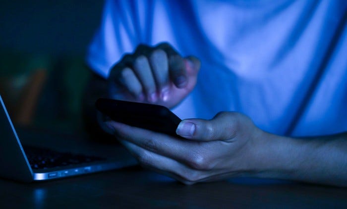 young person typing on a phone