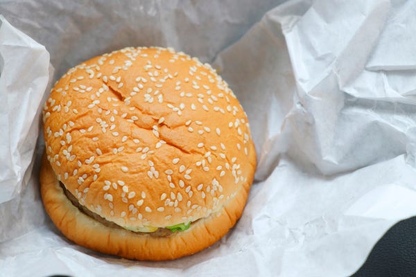 Hamburger sitting on a white wrapper