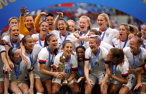 Carli Lloyd lifts the trophy as USA celebrate victory during the 2019 FIFA Women's World Cup.