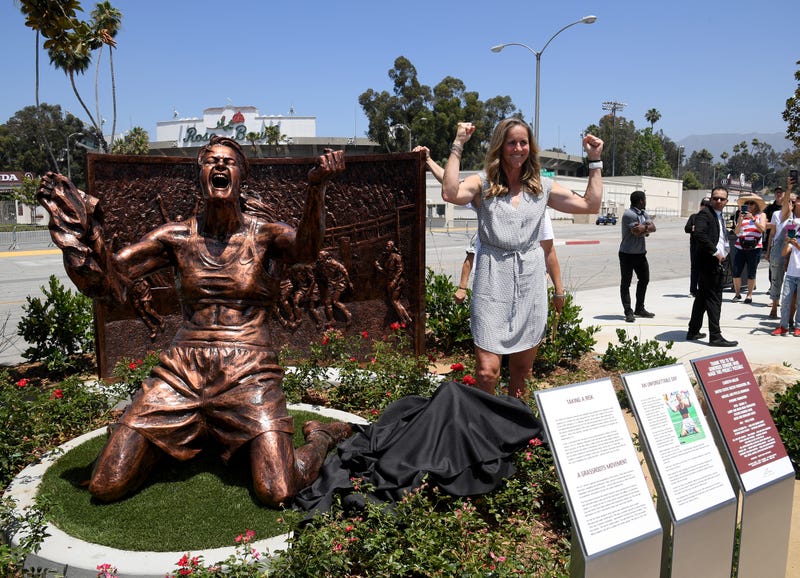 Brandi Chastain poses with statue of herself during an unveiling of a statue honoring the United States win at 1999 Women’s World Cup on July 10, 2019 at the Rose Bowl in Pasadena, California.