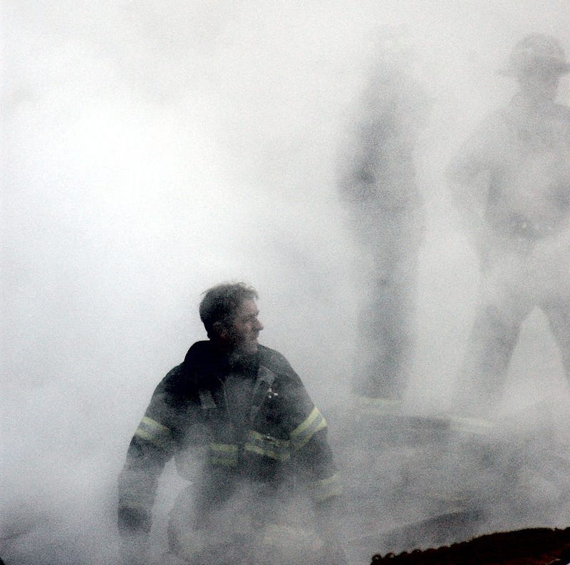 A firefighter emerges from the smoke and debris on Sept. 14, 2001