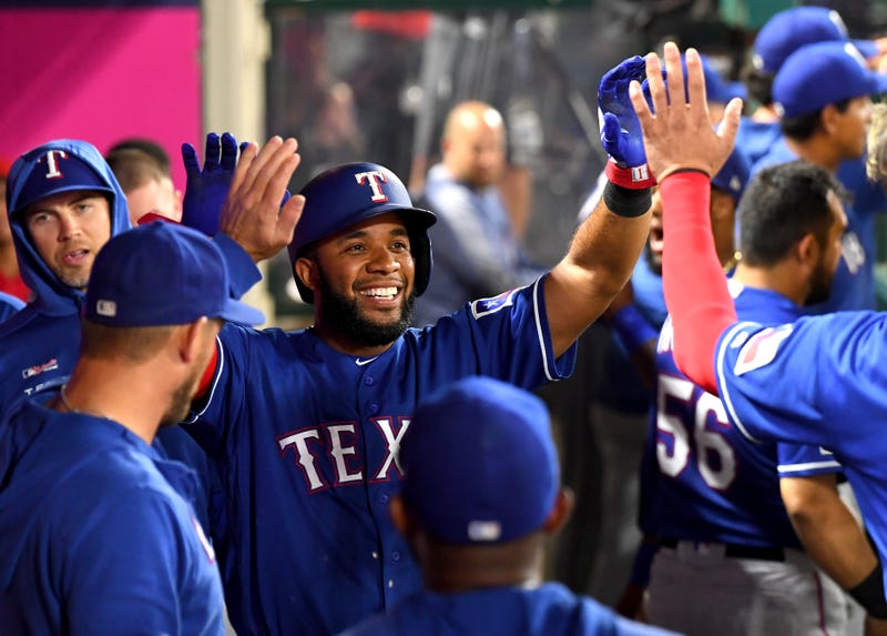 Elvis Andrus #1 of the Texas Rangers is greeted in the dugout after scoring a run in the sixth inning against the Los Angeles Angels at Angel Stadium on Aug. 28, 2019, in Anaheim, California.