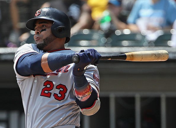 Nelson Cruz #23 of the Minnesota Twins hits a single in the 1st inning against the Chicago White Sox at Guaranteed Rate Field on July 28, 2019 in Chicago, Illinois. 