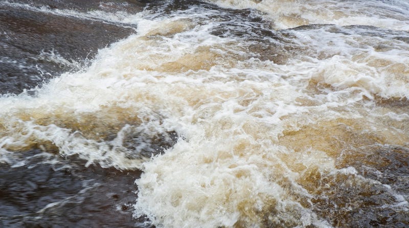 Rising river waters caused by a storm.