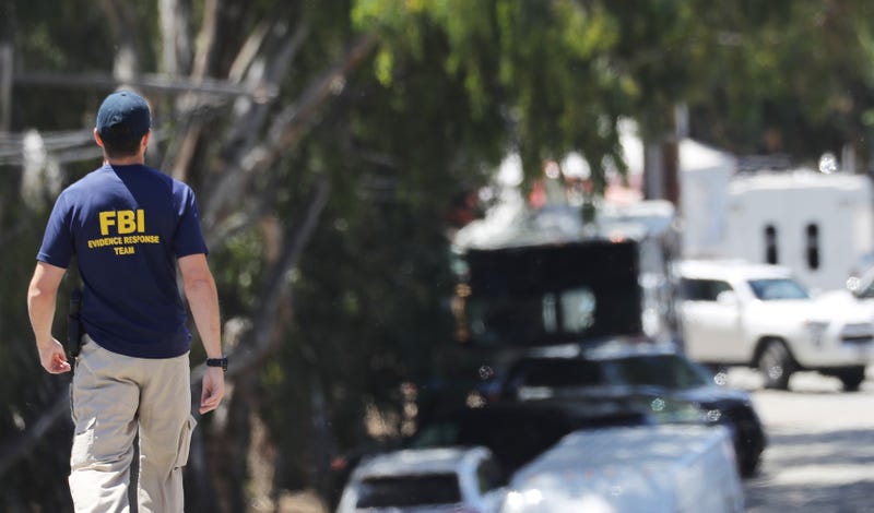 An FBI agent walks toward the site of the Gilroy Garlic Festival after a mass shooting took place there yesterday on July 29, 2019 in Gilroy, California.