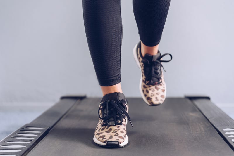 Woman walking on a treadmill.