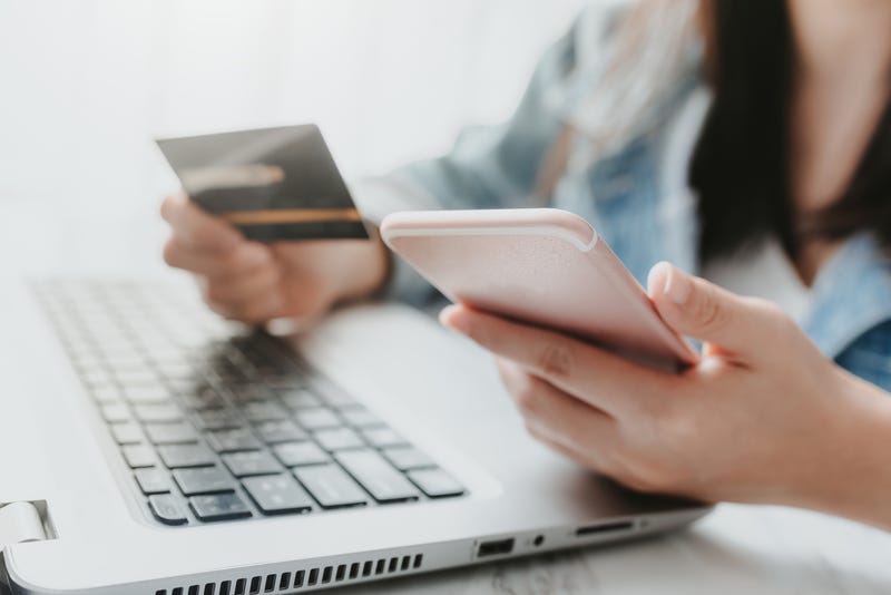 Woman holding a phone and a credit card