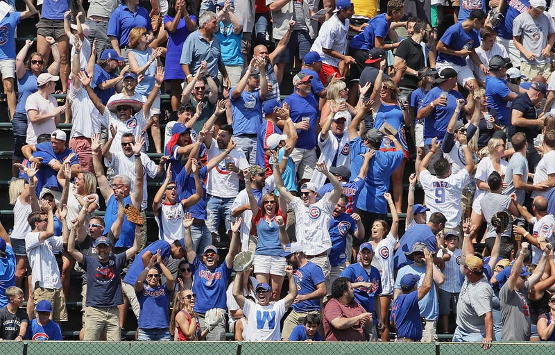 Fans in the bleachers cheer after Ian Happ of the Chicago Cubs hit a grand slam home run in the 4th inning against the Oakland Athletics at Wrigley Field on August 07, 2019 in Chicago, Illinois.