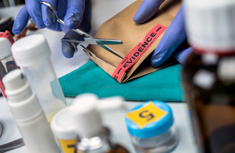 Scientific police opens a bag of evidence of a crime in scientific laboratory