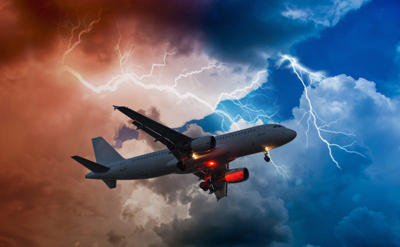 airplane flies in bad weather and storm with lightning bolt