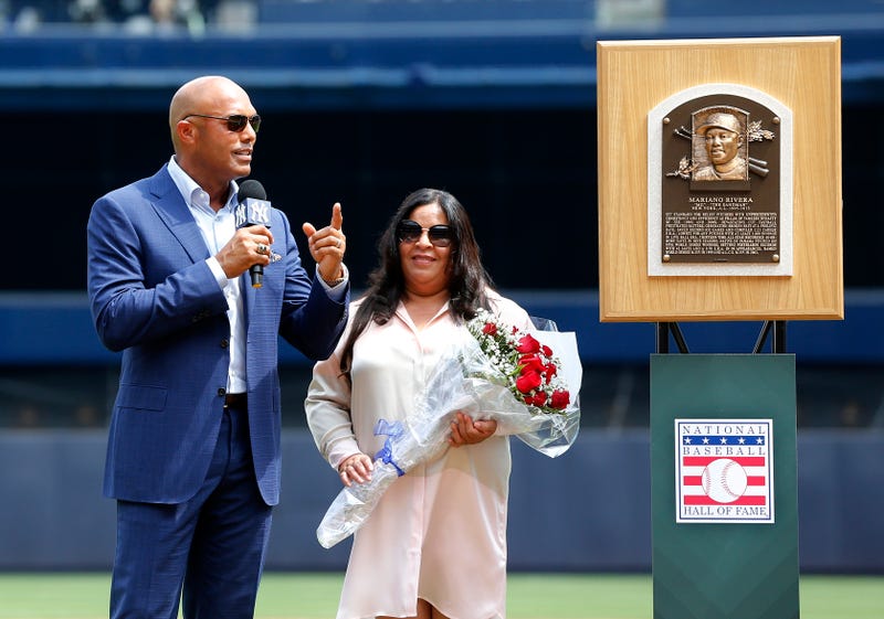 Former Yankee Mariano Rivera speaks to the crowd as he stands with his wife Clara next to his Hall of Fame plaque during a ceremony at Yankee Stadium on August 17, 2019