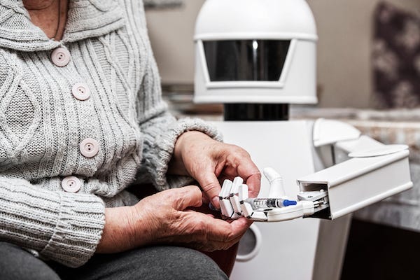 Elderly woman holding hands with a robot