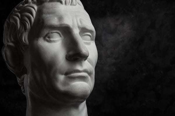 Gypsum copy of ancient statue Augustus head on dark textured background