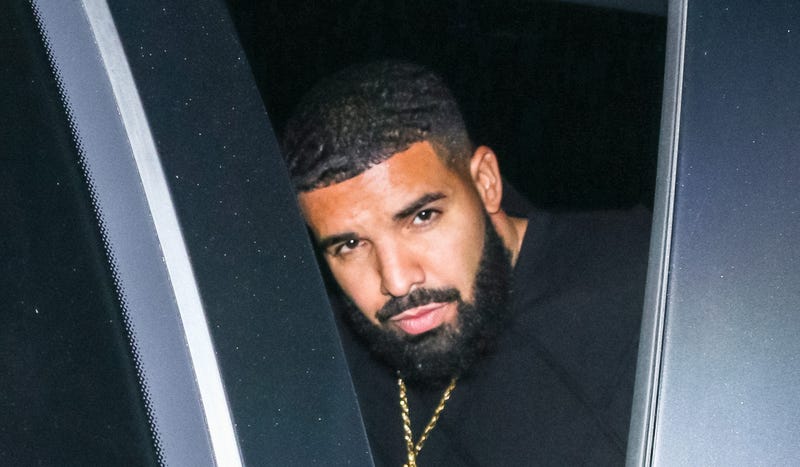 drake sitting in a car after an appearance