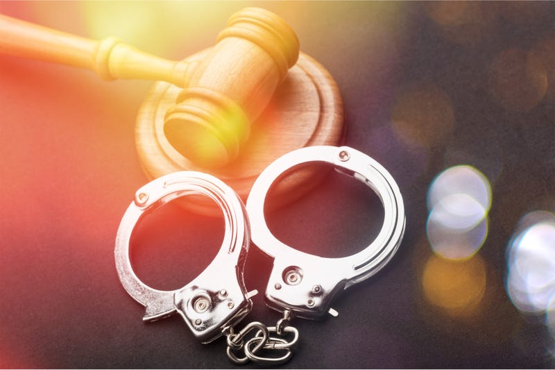 High Angle View Of Judge Gavel And Handcuffs