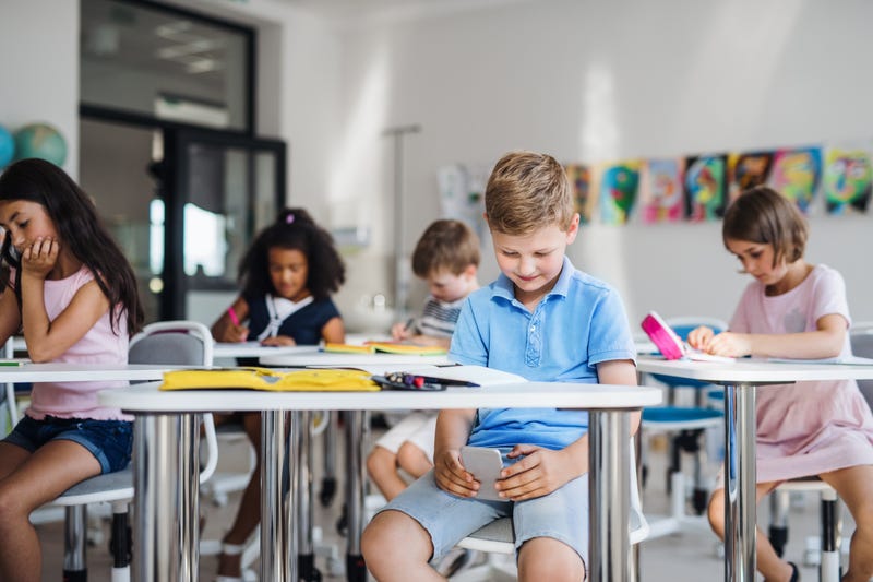 kids on phones in a classroom