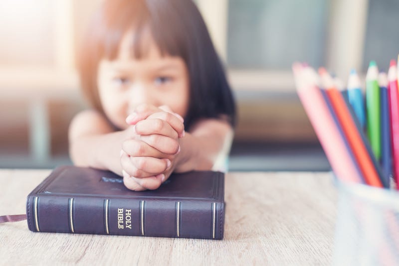 A child praying in school