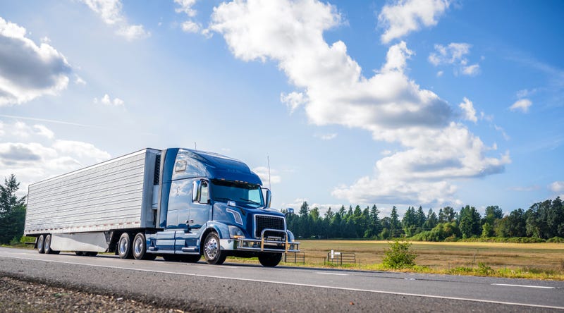 Commercial truck drives along highway
