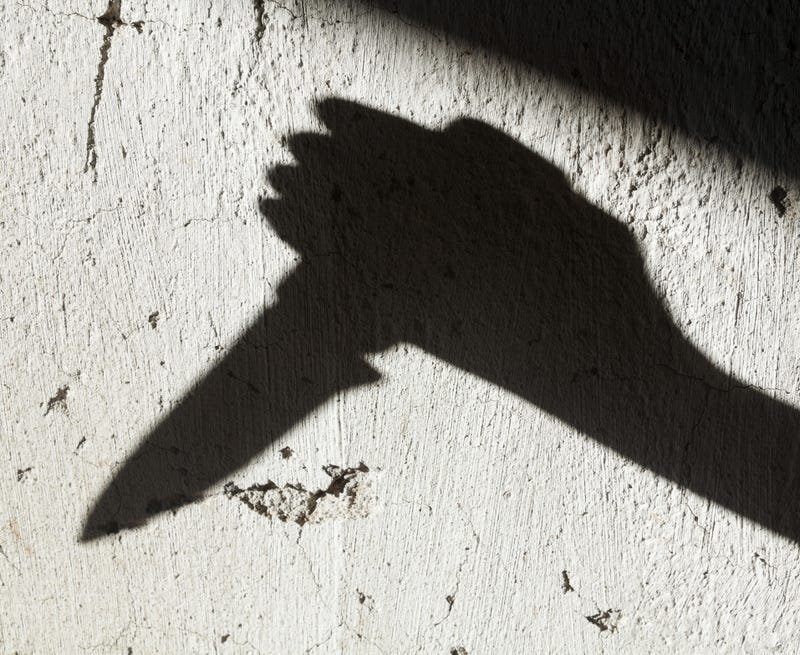 Shadow of hand with knife stock photo.