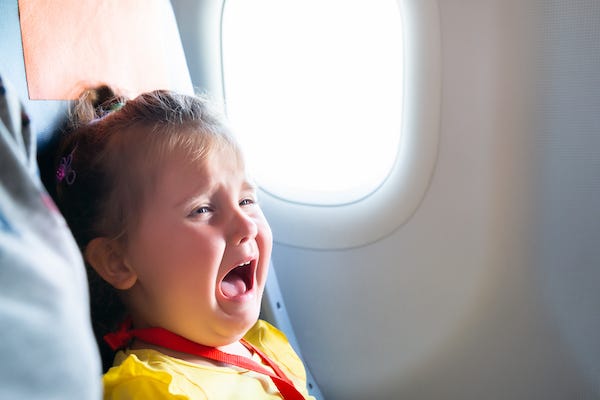Little girl crying on a plane