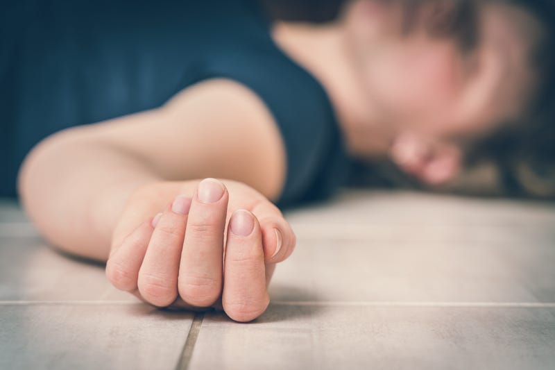 Dead woman lying on the white floor - suicide concept