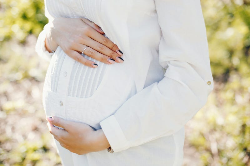 Pregnant woman in park.