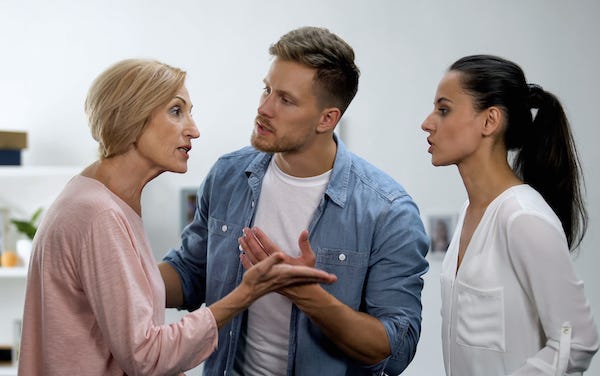Man trying to settle a conflict between his mother and his wife